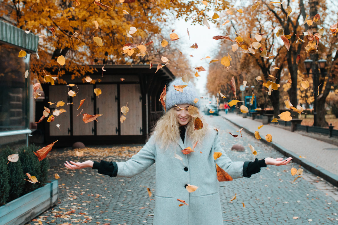 just be you carefree woman taking a walk on cobblestone street on autumn day