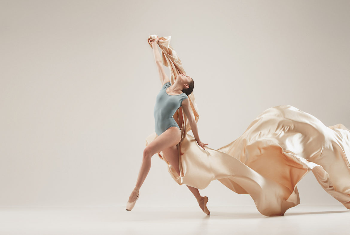 ballerina with silk fabric at the studio living her dream dancing
