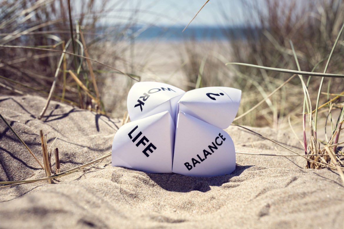 Origami with words, work, life, balance, ?, on the sand at beach where creativity leads to success