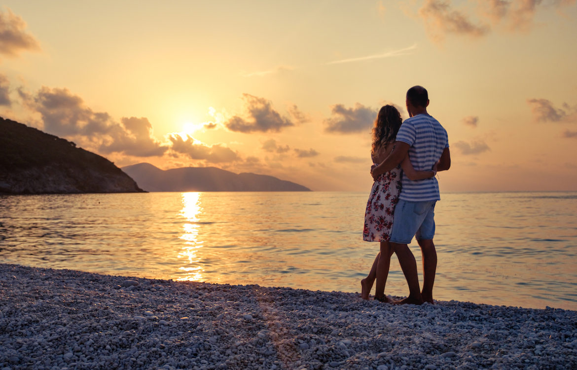how to set the stage for love couple embracing on the beach enjoying the view at sunset