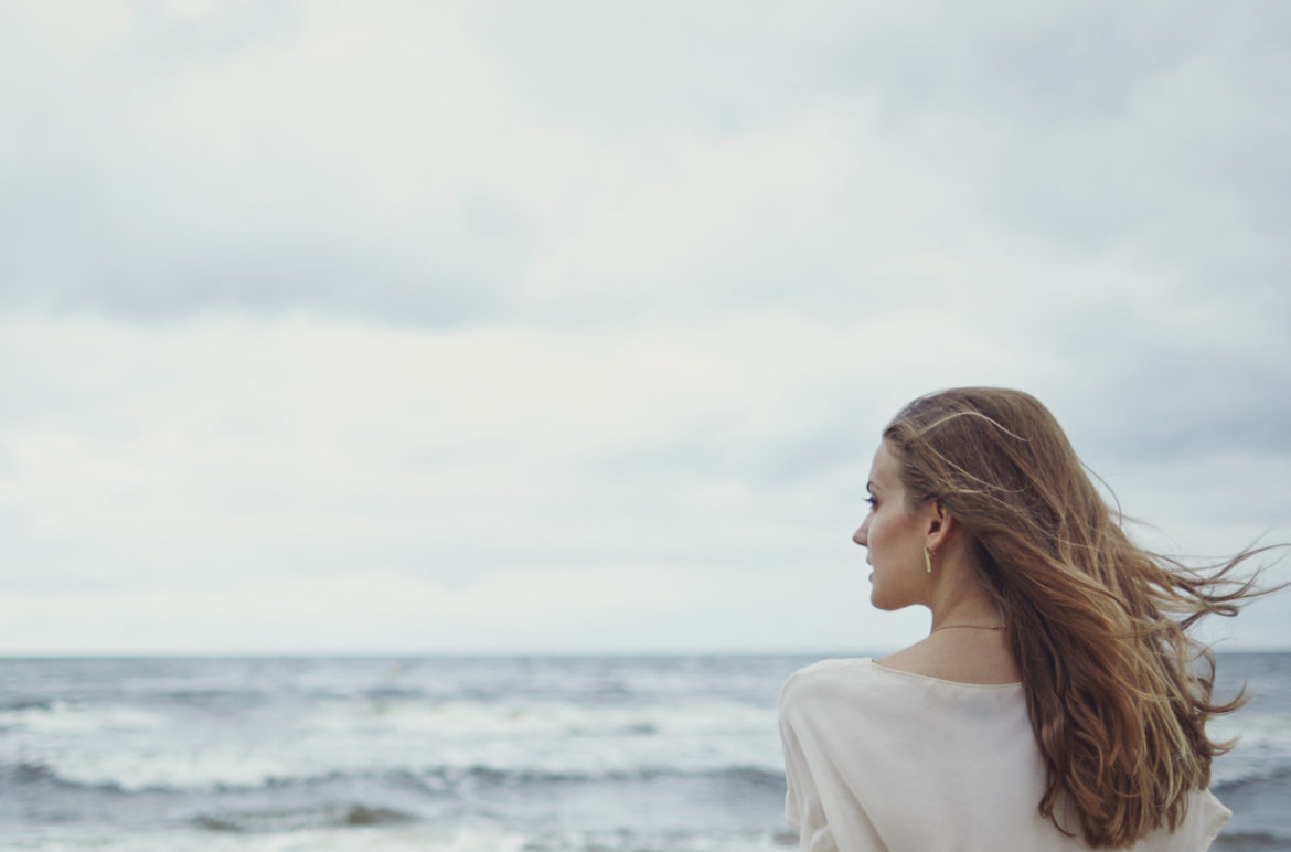woman spending time alone at the beach a journey to healing as she watches the waves