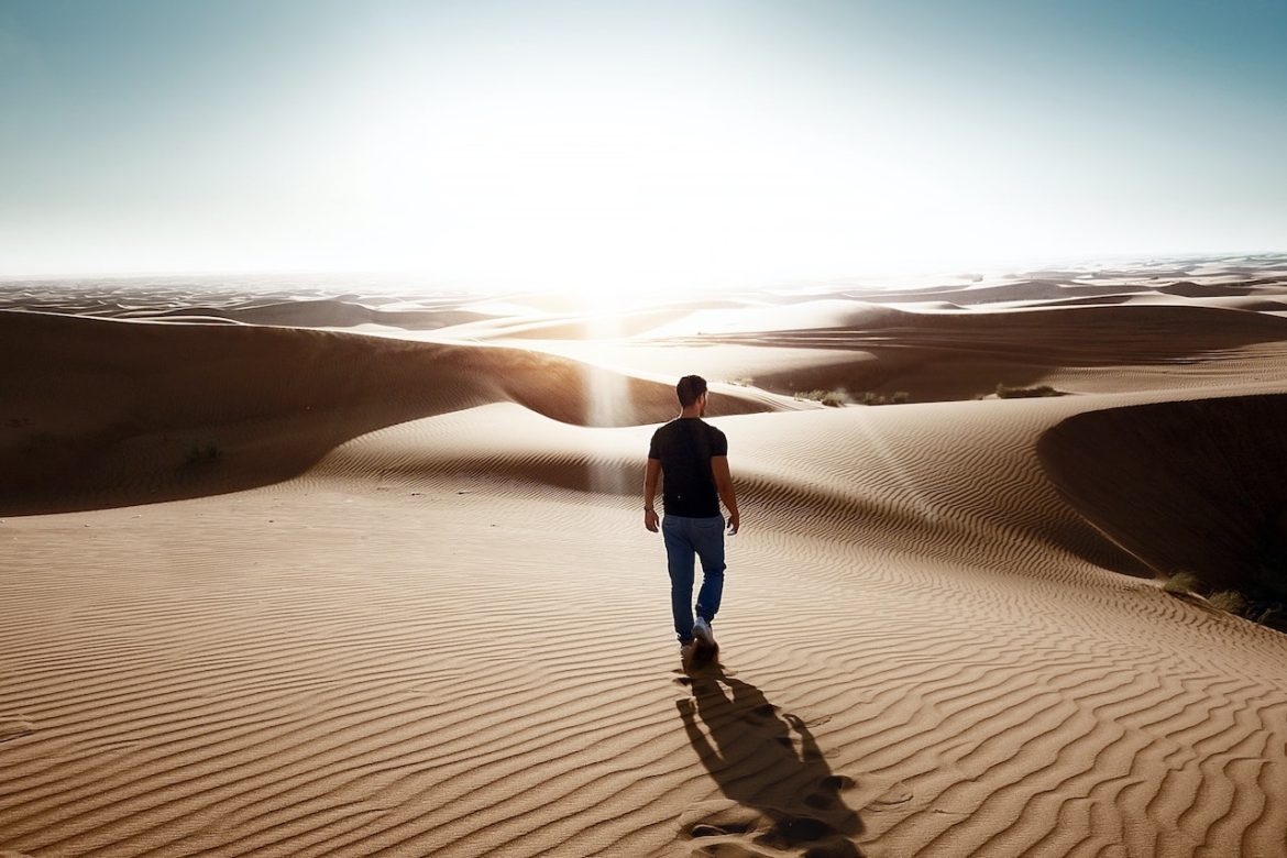 Realizing the importance of opening the lines of communication a little too late a man walks alone in the desert