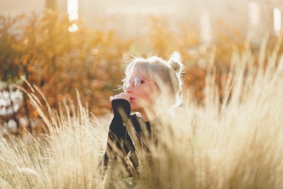 woman sitting in a field on a sunny autumn day feeling short-changed in a relationship