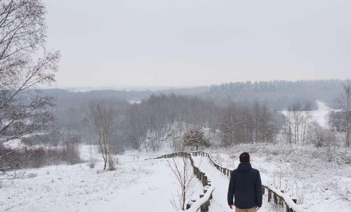 A man takes a solitary walk along a winding winter pathway in Veenendaal, Netherlands understanding life delivers hard lessons