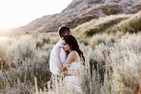 Couple embrace in the hillside meadow grateful for second chances