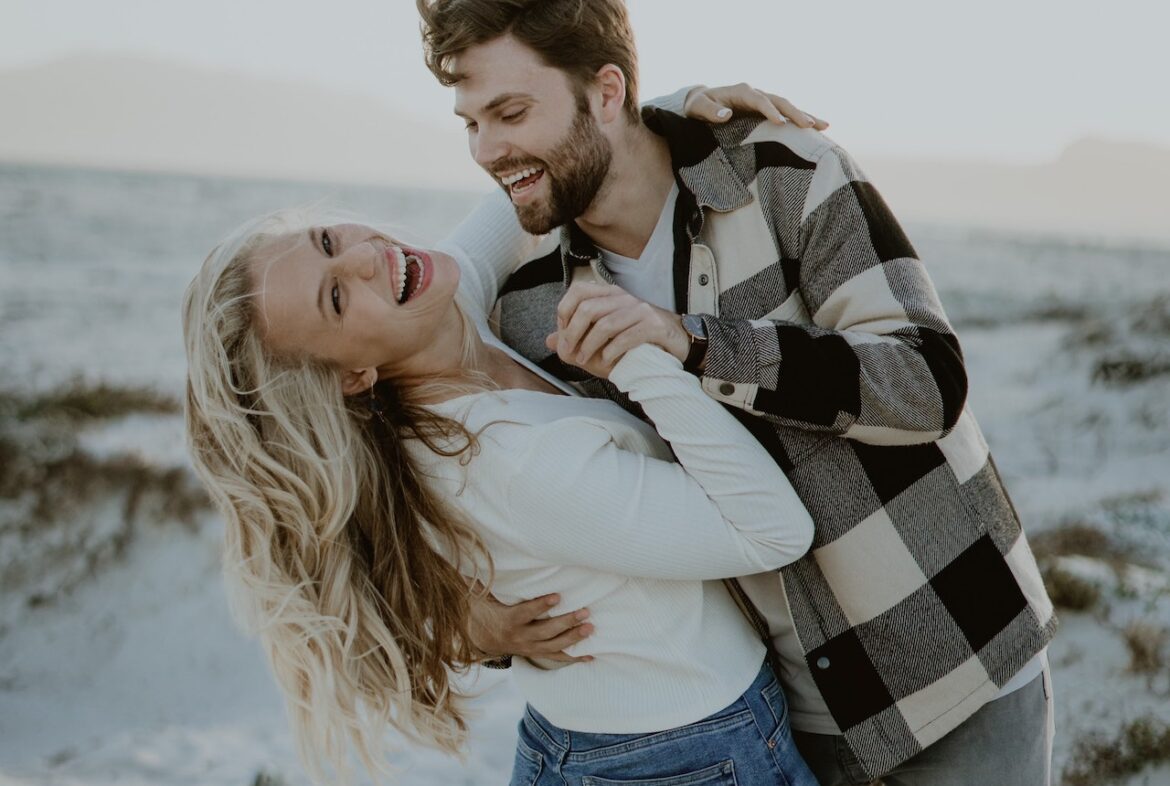 What will it take to attract attractive people, couple enjoying time together, dancing on the beach.