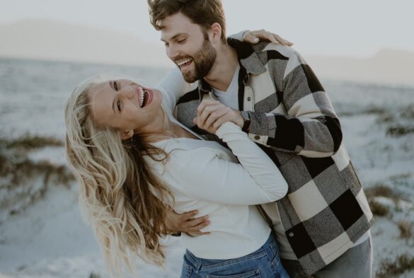 What will it take to attract attractive people, couple enjoying time together, dancing on the beach.