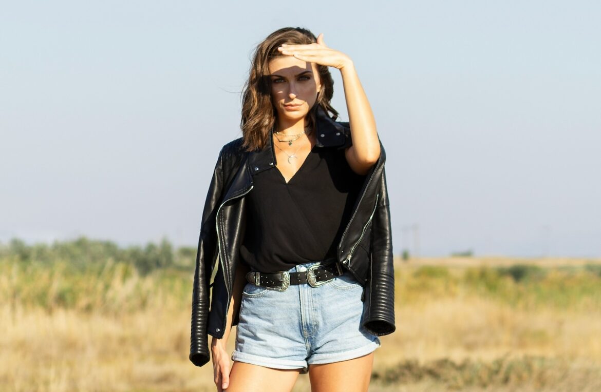 With without dating standards a choice that must be made by this young woman standing on a prairie field on a nice sunny cloud free day.