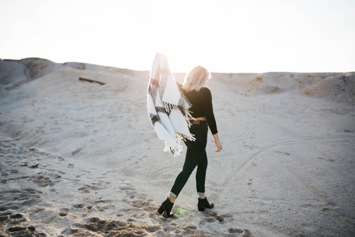 On a sunny cool summer's day, she walks away from a toxic relationship with her shawl held high, she moves onwards and upwards on a sand dune.